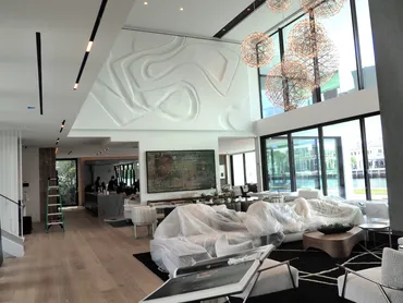 Sculpted relief ceiling panel finished above a double-height living room