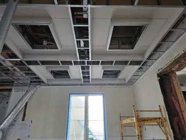Recessed ceiling trays hung in drywall across an interior room
