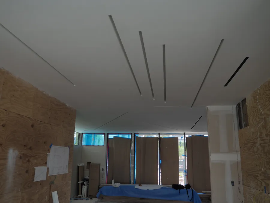 Finished ceiling with linear light reveals